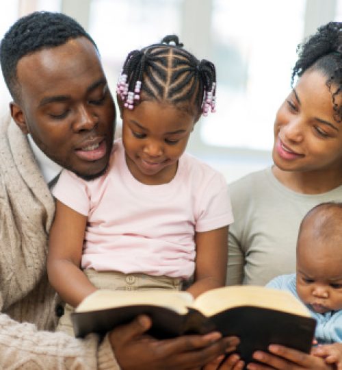 African American Family studying bible together